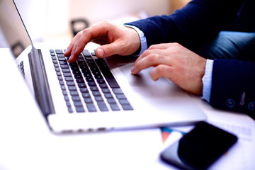 Obraz na płótnie Canvas businessman working at a computer hands closeup