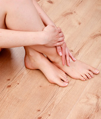 Obraz na płótnie Canvas pedicure on legs and beautiful manicure on hands closeup