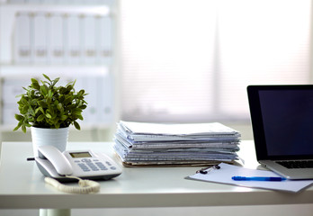 Fototapeta premium a stack of papers on the desk with a computer