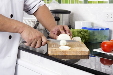 Chef cutting onion for making Hamburger
