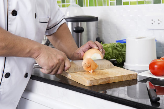 Chef cutting onion for making Hamburger