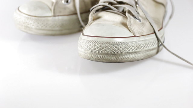old sneakers on white background 