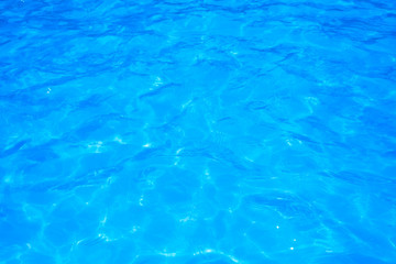 Blue pool water with sun reflections