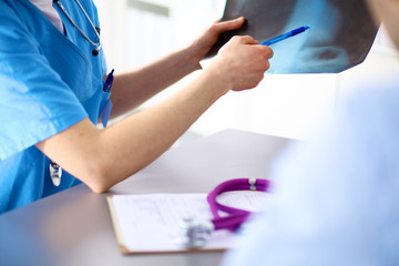 doctor with stethoscope on the patient's admission at the table