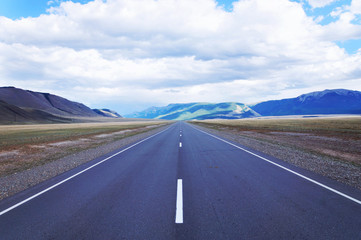 Straight as an arrow road at the highland plain