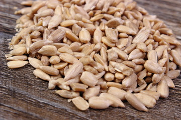 Heap of sunflower seeds on wooden background