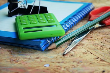 Mix book and calculator, stapler, tape, paper punch, pencil