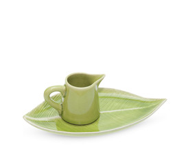 green teapot with saucer isolated on white background