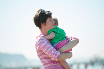 mom and baby on beach  have fun