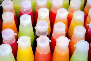 Assortment of cold tropical fruit juice in bottles
/ Bottle of juice view from above
