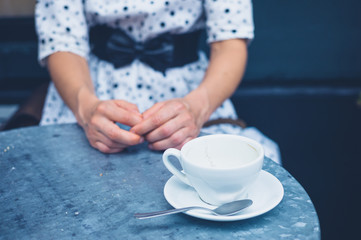 Woman at table with empty coffee cups