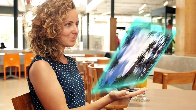 Futuristic Technology Concept. Girl Use Hologramic Media Payer
