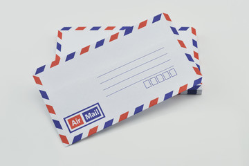 Stack of air mail envelopes on white background