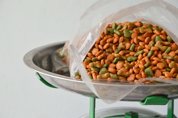 dog food in plastic bag on stainless weighting scale tray