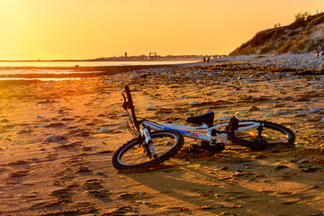 Fototapeta na wymiar Bmx bike on beach in France at sunset