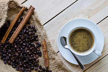 White coffee cup and coffee beans around