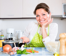 Obraz na płótnie Canvas Happy woman in contemporary kitchen