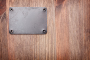 A Wooden background with metal label