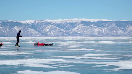 People travel on frozen Lake Baikal 
Extreme winter journey across the ice deep reservoir