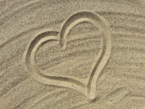 love symbol write on the beach