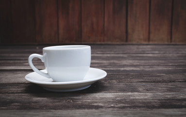 White coffee cup with wood background