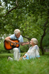 Fototapeta premium Mature couple with guitar in park