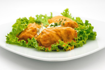 Forcemeat wrapped in cabbage leafes and boiled isolated on white