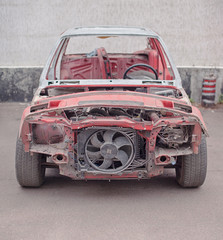 Front view of red old rusty car