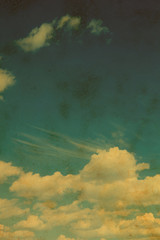 Fototapeta na wymiar Blue sky with clouds in grunge and retro style.
