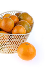 orange fruit in basket, isolated on white background