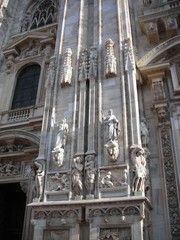Fototapeta premium Details from the facade of Milan Cathedral (Duomo di MIlano), built in roch Gothic style in white marble.
