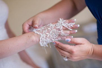 Hands of the bride with glove