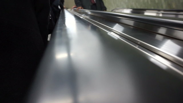 Hand And People Riding Up Escalator To City Streets From Subway Abstract Work