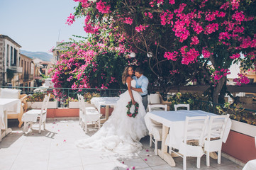 wedding couple in a cafe on summer terrace, Greece