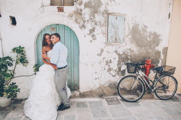 The bride and groom in front of wooden doors