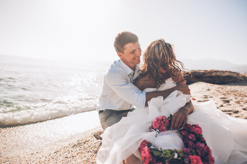Bride and groom on the beach on their wedding day