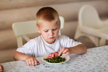 child eats at the table