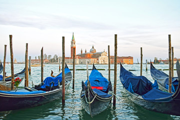 Obraz na płótnie Canvas Gondolas moored by Saint Mark square with San Giorgio di Maggiore church in the background - Venice, Venezia, Italy, Europe