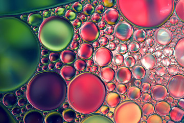 Oil drops on water surface, abstract macro background.
