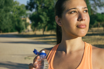 Runner woman drinking water