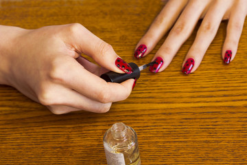   The process of applying for the varnished nails topcoat.