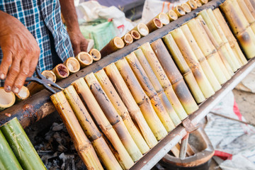 Glutinous rice roasted in bamboo joint, Thai dessert.