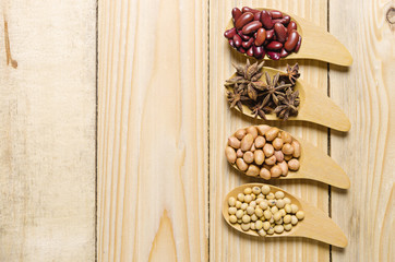 beans in wooden spoon on wood table
