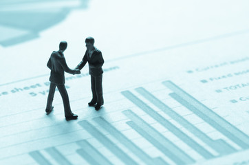 miniature business man on the graph