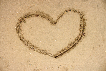 drawn heart shape on sand