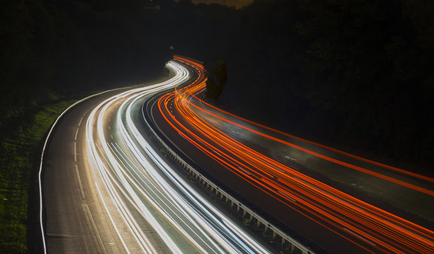 Running Car Lights At Night On The Road.