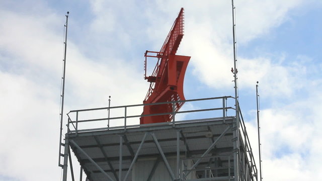 A radar tower used to track airplanes rotates in circles.