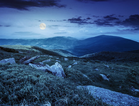 stones in valley on top of mountain range at night