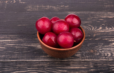 Red plums in a bowl