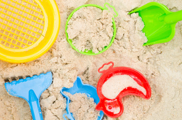 Fototapeta na wymiar plastic toys in sandpit